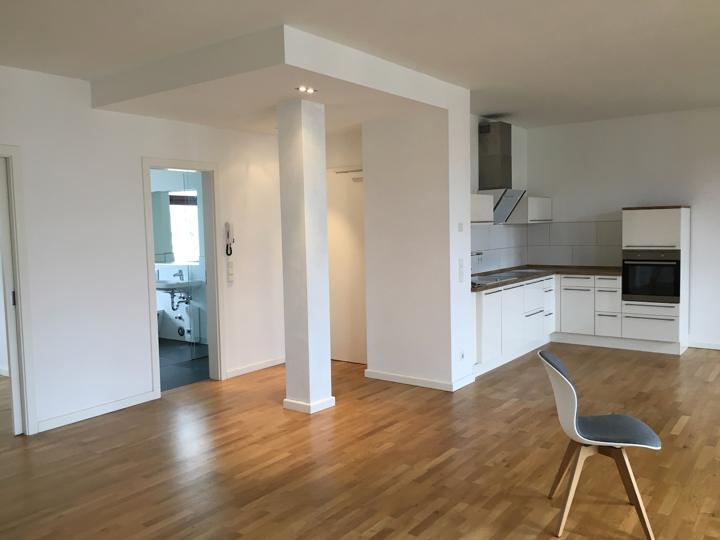 Before: empty open-plan kitchen and living area photo