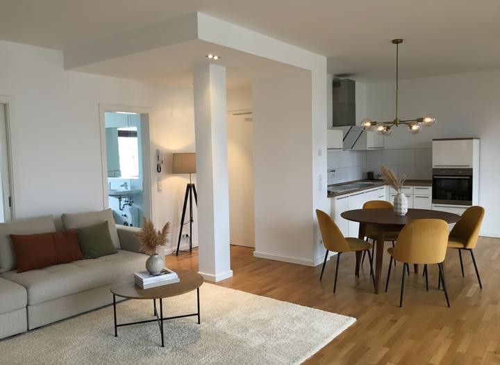 After: open-plan kitchen and living area virtually staged in warm modern style by Virtual Stage Now