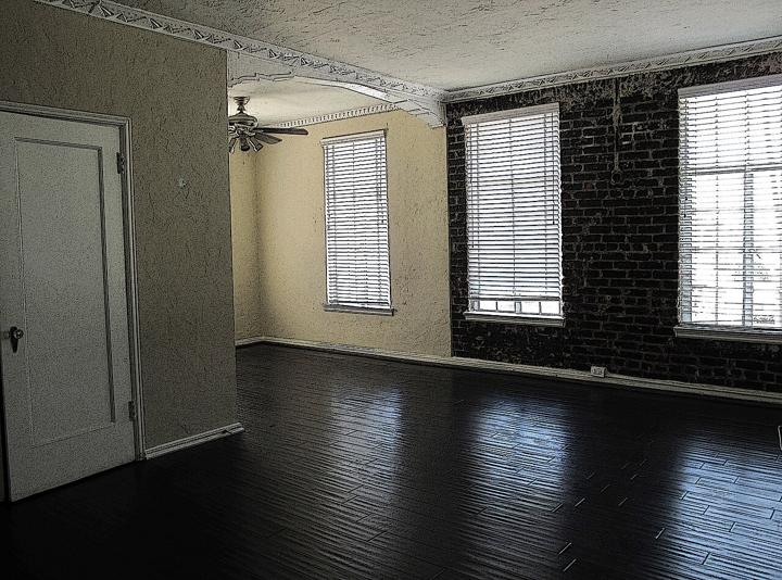 Before: empty loft living room with exposed brick photo